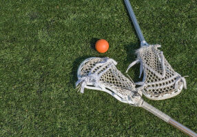 Lacrosse sticks and ball on artificial turf. Great for background .